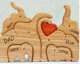 A Wooden Statue Of The Elephant Family At Home